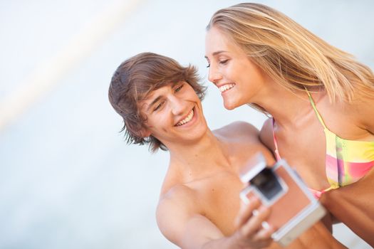 beautiful teenager couple taking selfie with old camera on the beach







beautiful young couple taking selfie with old camera on the beach