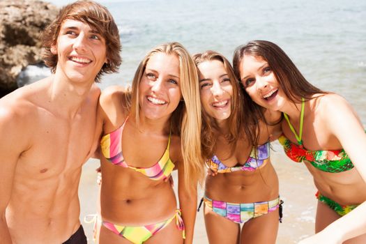 young beautiful friends group laughing on the beach