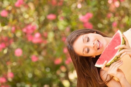 Portrait of a beautiful young woman eating watermelon