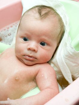 Swimming baby boy at the bath