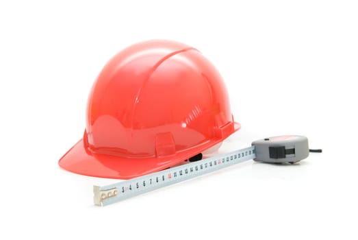 Red Safety helmet and measuring tape isolated on white