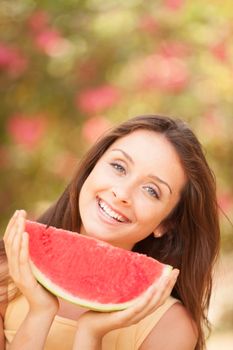 Portrait of a beautiful young woman eating watermelon