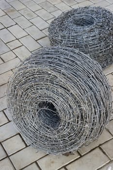 Two bays of barbed wire on the sidewalk
