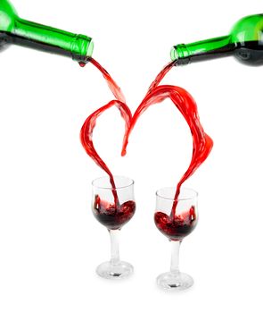 Heart from pouring red wine in goblet isolated on white