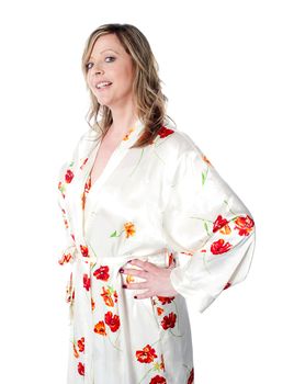 Glamorous female wearing gown posing with hands on her isolated waist over white background