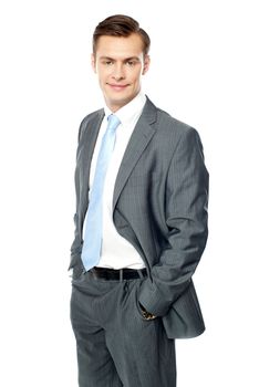 Smiling entrepreneur posing with hands in pocket. Looking at camera