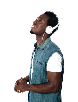 African guy lost in musical world. Isolated and looking upwards