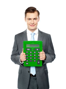 Corporate man showing big green calculator standing over white background
