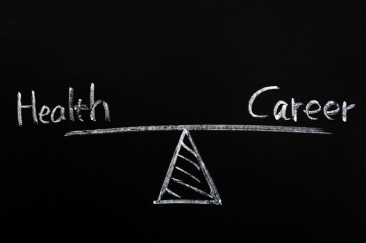 Balance of health and career drawn with white chalk on a blackboard