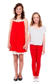Full length portrait of beautiful sisters holding each others hand