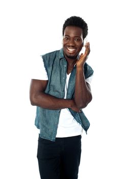 African teen boy enjoying music holding headphones