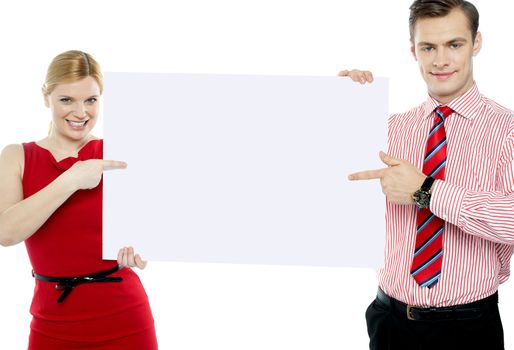 Business colleagues pointing at blank signboard isolated against white background