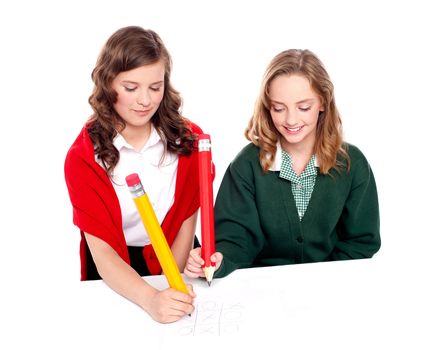 Teenager friends playing ouths and crosses with big pencil on white