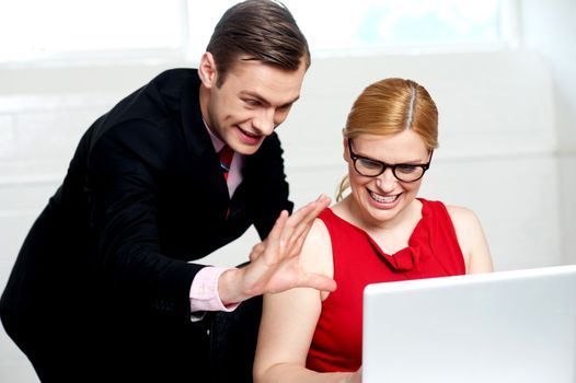 Business people having fun at work. Man expressing something with hands