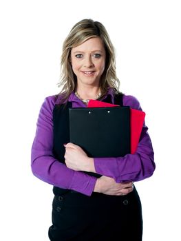 Beautiful smiling woman holding documents. Looking at camera and smiling