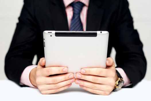 Businessman's hands holding portable device with touch screen technology