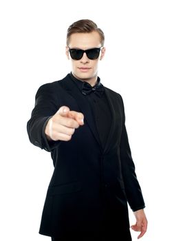 Handsome man indicating towards you isolated against white background