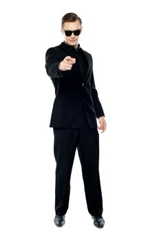 Man in party wear attire pointing at camera wearing black goggles
