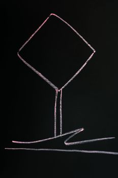 Blank warning sign drawn with red chalk on a blackboard background