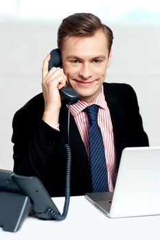 Smart businessman communicating on phone inside the office