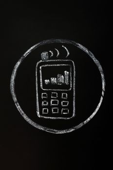Chalk drawing of mobile phone symbol on blackboard background