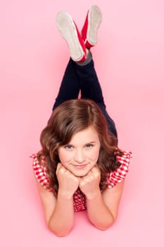 Portrait of cute fashionable trendy girl against pink background