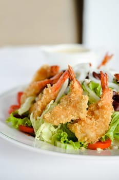 close up of fried shrimp and vegetable salad