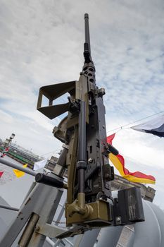 machine gun on warship against dark sky
