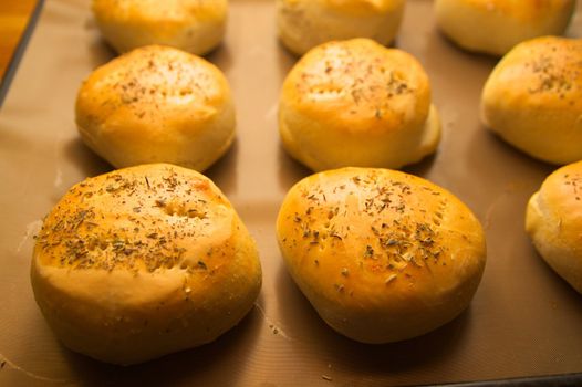 Freshly baked hamburger breads on a plate