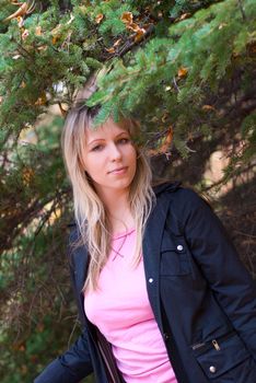 Beautiful girl portrait at autumn coniferous forest
