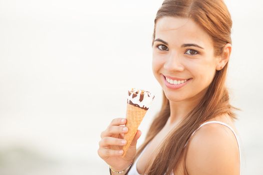 portrait of a young beautiful woman eating ice-cream cone