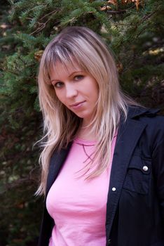 Beautiful girl portrait at autumn coniferous forest
