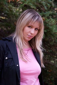 Beautiful girl portrait at autumn coniferous forest
