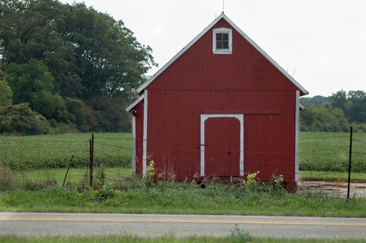 A little red barn sits by the side of the road in rural Michigan