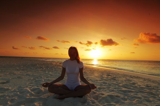 sunset yoga woman on sea coast