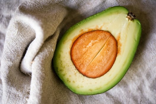 Avocado halve on a canvas background. Shallow DOF