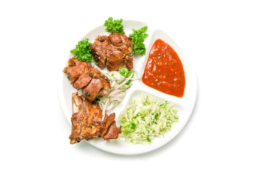 Roast meat with sauce and vegetables isolated on white background