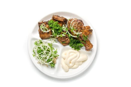 Grilled meat with sauce and vegetables isolated on white background