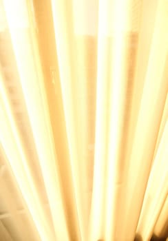 Sunlight falling through a semi transparent curtain.