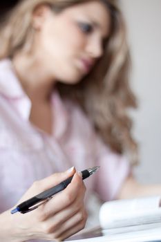 young beautiful woman reading a book at home