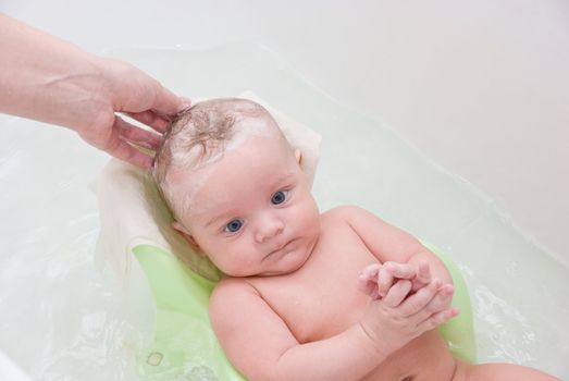 mother washing her son at bathing stand 