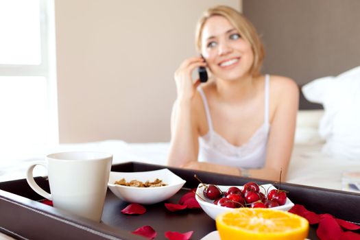 young beautiful woman using cellphone device during breakfast