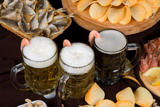 Beer and snacks set: chips, pistachio, shrimp and fish
