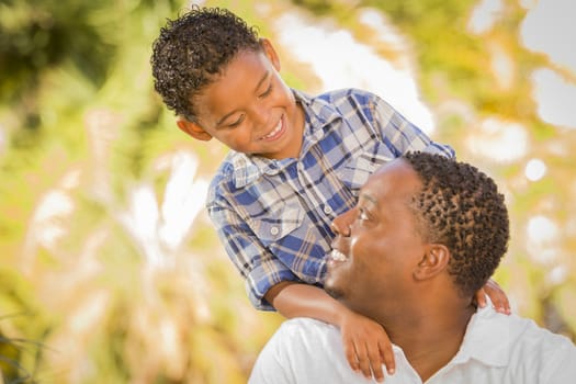 Happy Mixed Race Father and Son Playing in the Park.