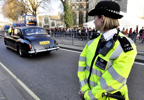 LONDON, UK - MARCH 12: A police woman outside Westminster Abbey where Queen Elizabeth II attends the Commonwealth Day ceremony on March 12, 2012 in London, UK.