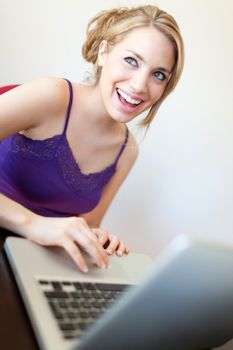 young beautiful white women using a laptop when laughing