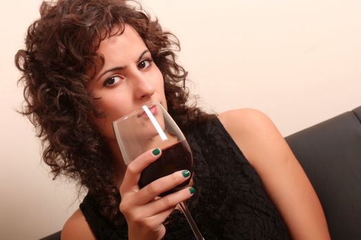 Portrait of a beautiful, latin Woman drinking red wine.