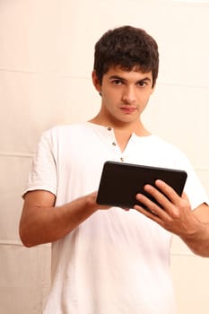 A young hispanic man using a Tablet PC.