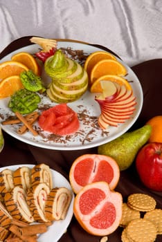 Set of sweet fruit and cake on a restaurant table  background