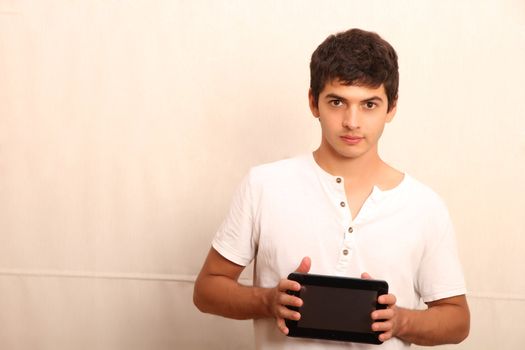 A young, latin man with a Tablet PC, face in focus
